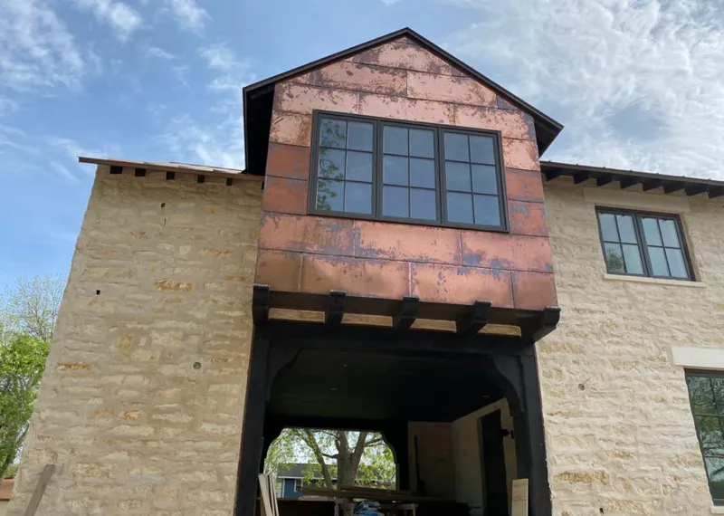 Copper metal panel facade on a stone building for Skylight Installation in Nacogdoches