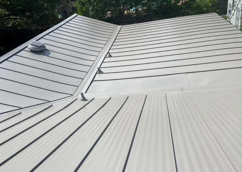Solar attic fan installed on a metal roof for Roof Ventilation in Nacogdoches